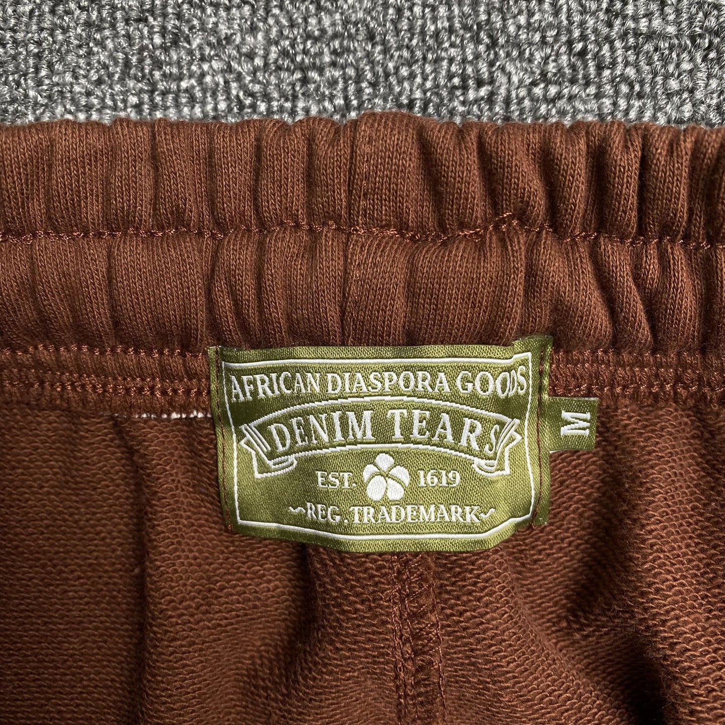 DENIM TEARS THE COTTON WREATH SWEATPANTS BROWN