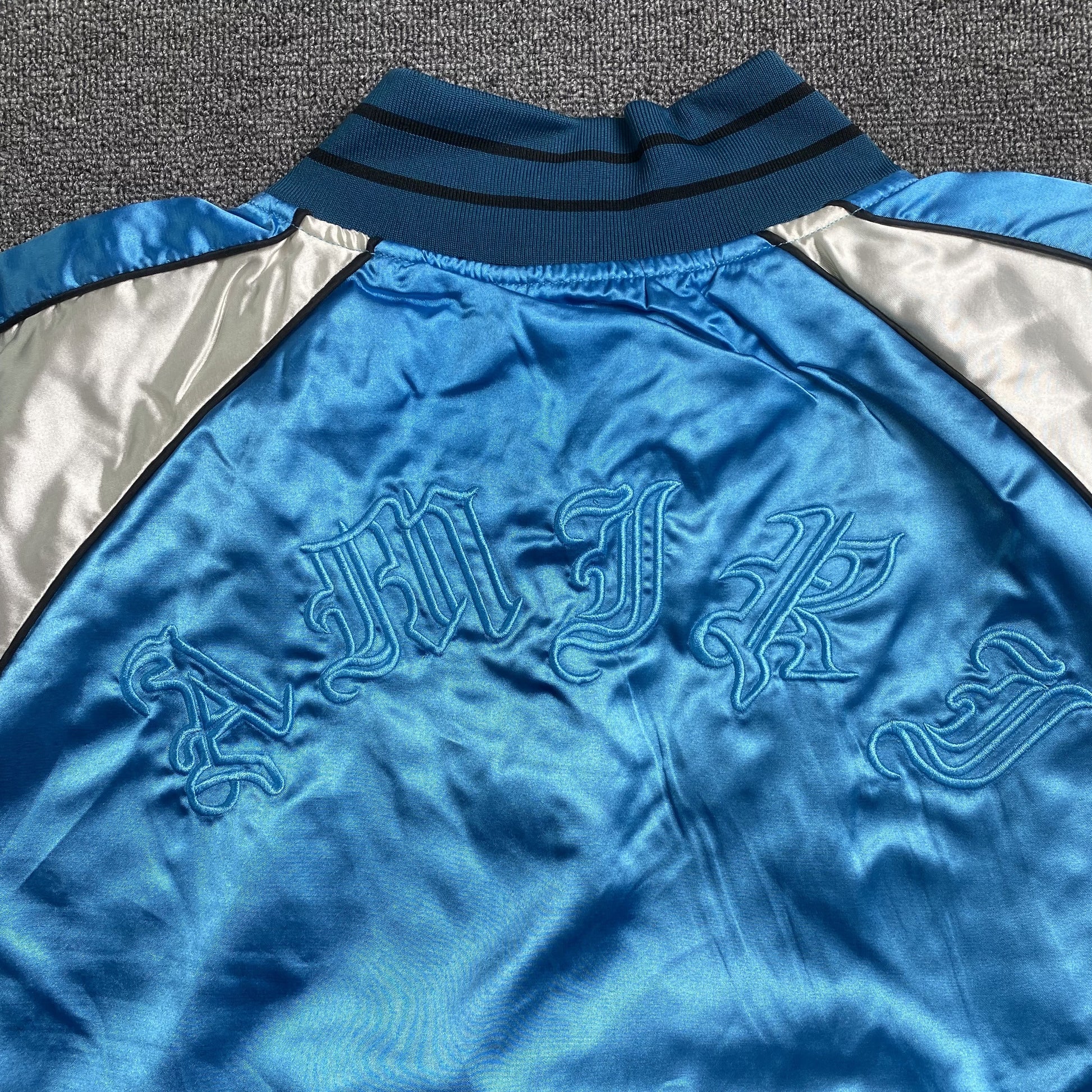 amiri-satin-flames-souvenir-varsity-bomber-jacket-blue-8-Drip Store Argentina