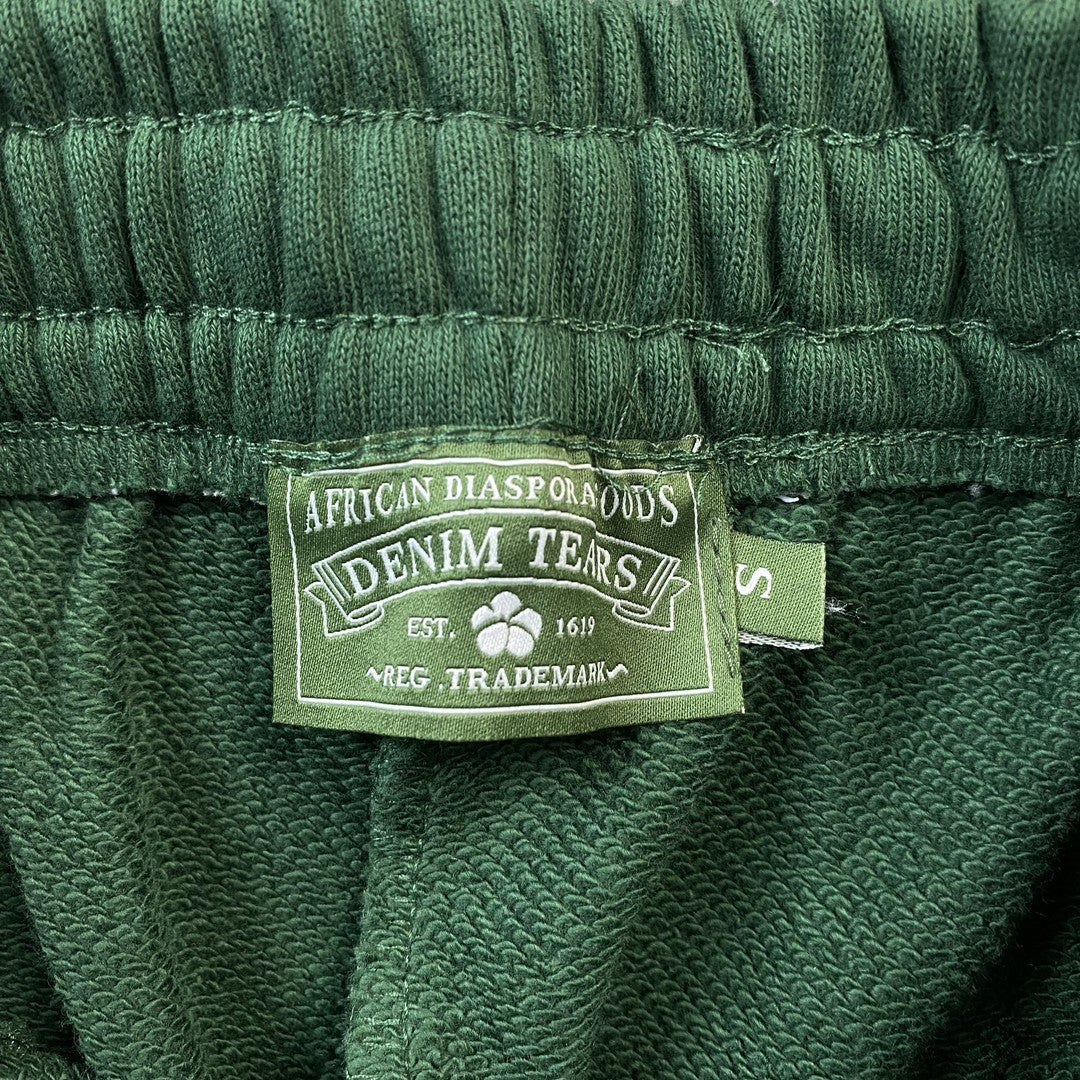 denim-tears-the-cotton-wreath-sweatpants-green-5-Drip Store Argentina