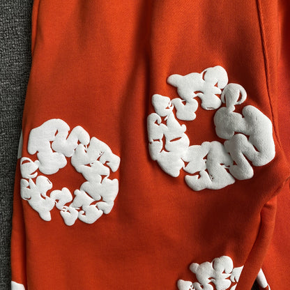 denim-tears-the-cotton-wreath-sweatpants-orange-3-Drip Store Argentina