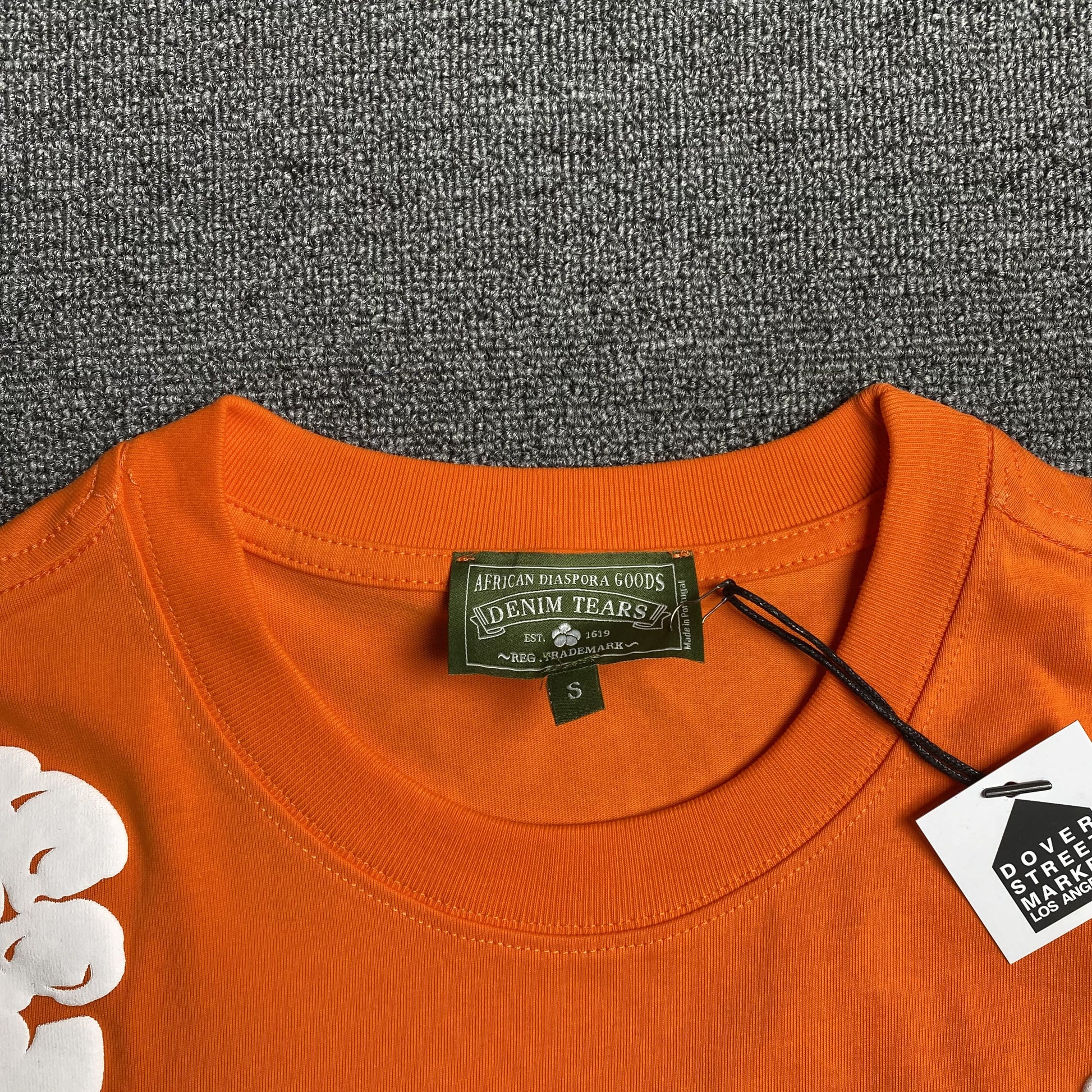 denim-tears-the-cotton-wreath-tee-orange-3-Drip Store Argentina